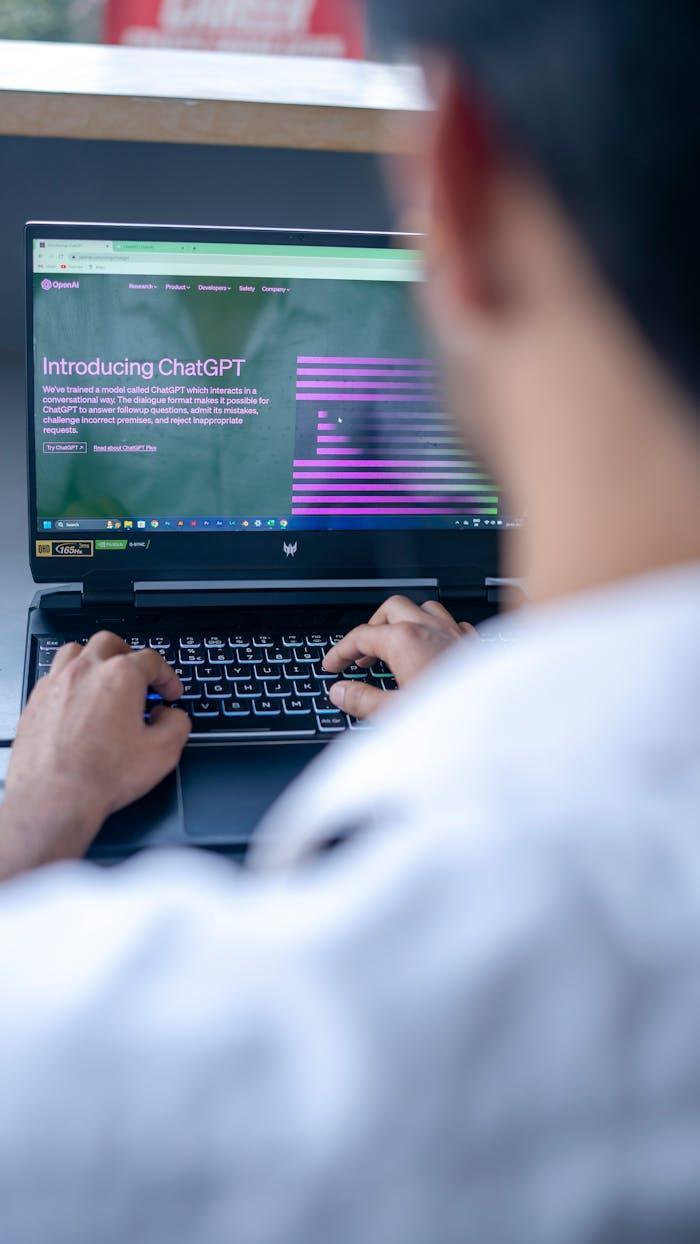 Man Typing on Laptop